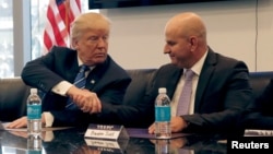 FILE - Donald Trump, Republican presidential nominee at the time, shakes hands with Brandon Judd, President of the National Border Patrol Council, while receiving the group's endorsement during a meeting at Trump Tower in New York, Oct. 7, 2016.