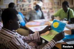 FILE - Patients undergoing a rehabilitation program draw during a therapy session at the Sopi Jikko center for people with mental health and drug addiction problems in Dakar..
