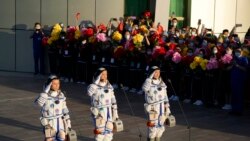 Chinese astronauts, from left, Tang Hongbo, Nie Haisheng,a nd Liu Boming on June 17, 2021. (AP Photo/Ng Han Guan)