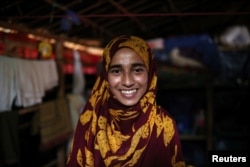 Formin Akter smiles as she poses for a picture before heading to Chittagong to attend school at the Asian University for Women, in Cox's Bazar, Bangladesh, Aug. 24, 2018.