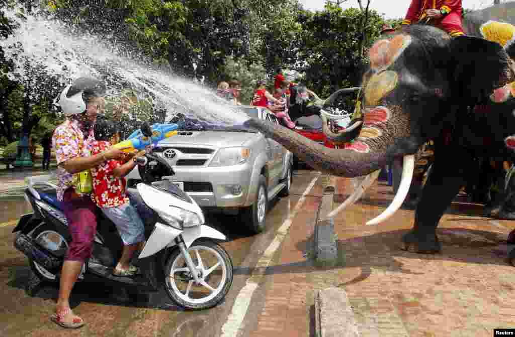Elephants spray villagers with water in celebration of the Songkran water festival in Thailand&#39;s Ayutthaya province, north of Bangkok. Songkran, the most celebrated festival of the year, marks the start of Thailand&#39;s traditional New Year.
