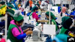 FILE: Garment employees work in a sewing section of the Snowtex Outerwear Ltd. factory in Savar, Bangladesh, on Aug. 9, 2021