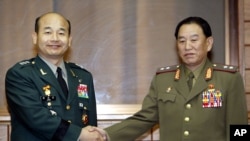 FILE - South Korean chief delegator Army Maj. Gen. Jeong Seung-jo, left, shakes hands with his North Korean counterpart Lt. Gen. Kim Yong Chol before a military meeting at the North side of the border village of Panmunjom, North Korea.