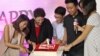 Google officials and partners cut into a birthday cake marking YouTube's first year with a Vietnamese version. (Lien Hoang/VOA News)