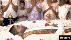 FILE - The family of Nadarajah Raviraj, a prominent member of the Tamil National Alliance who was assassinated the previous day, pay their respects over his body in Colombo, Nov. 11, 2006.