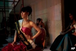 FILE - In this Nov. 11, 2016 photo, contestants wait backstage during the Miss Transgender Indonesia pageant in Jakarta, Indonesia.