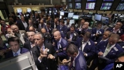 Trading in AIG stock resumes at the New York Stock Exchange, August 3, 2012. 