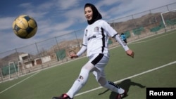 FILE - A female soccer player controls a ball during a training session at the Golab Trust Sport Complex in Kabul, Afghanistan. 