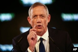 FILE - Retired Israeli military chief Benny Gantz speaks at the official launch of his election campaign for the April 2019 polls, in Tel Aviv, Jan. 29, 2019.