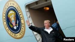 President Donald Trump waves while departing Ellington Field after meeting with flood survivors and volunteers who assisted in relief efforts in the aftermath of Hurricane Harvey, in Houston, Texas, Sept. 2, 2017.