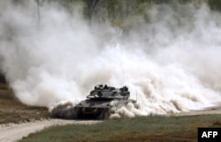 FILE - An Israeli army tank patrols along the border between Israel and the Gaza Strip, May 29, 2018.