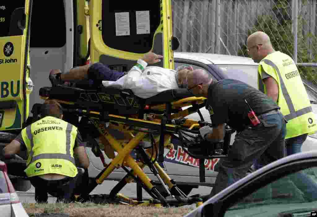 Ambulance staff take a man from outside a mosque in central Christchurch, New Zealand, Friday, March 15, 2019. 