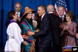 FILE - President Barack Obama greets Our Sisterís Keeper Executive Director Diane Millich, from left, and Tulalip Tribes of Washington State Vice Chairwoman Deborah Parker, after signing the Violence Against Women Act in Washington, D.C., March 7, 2013.