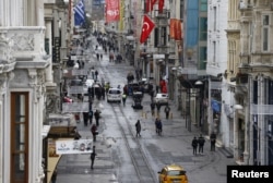 Pedestrians walk along Istiklal street, a major shopping and tourist district, in central Istanbul, Turkey March 20, 2016, a day after a suicide bomb attack. REUTERS/Osman Orsal - RTSBACA