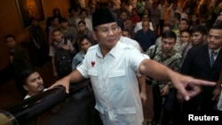 Indonesian presidential candidate Prabowo Subianto gestures after a meeting with members of his coalition in a hotel in Jakarta, July 20, 2014.