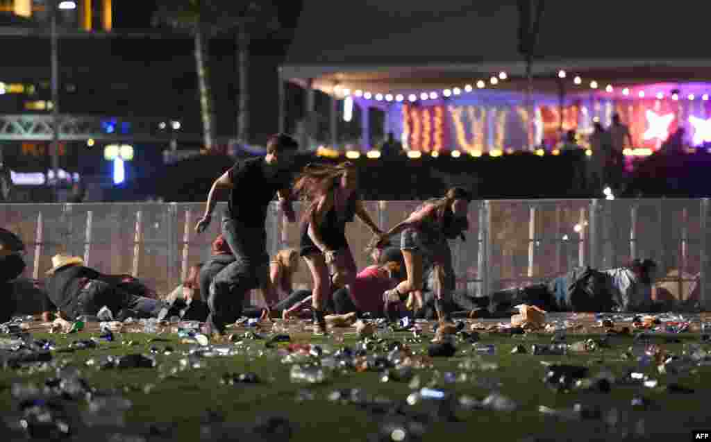 People run from the Route 91 Harvest country music festival after apparent gun fire was heard in Las Vegas, Nevada, Oct. 1, 2017. The gunman, identified as Stephen Paddock, 64, of Mesquite, Nevada, allegedly opened fire from a room on the 32nd floor of the Mandalay Bay Resort and Casino on the music festival, leaving at least 58 people dead and over 500 injured.