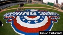 PNC Park ground crew member Matt Gerhardt paints the field, Wednesday, March 30, 2016, in preparation for the 2016 Major League Baseball season opening series.