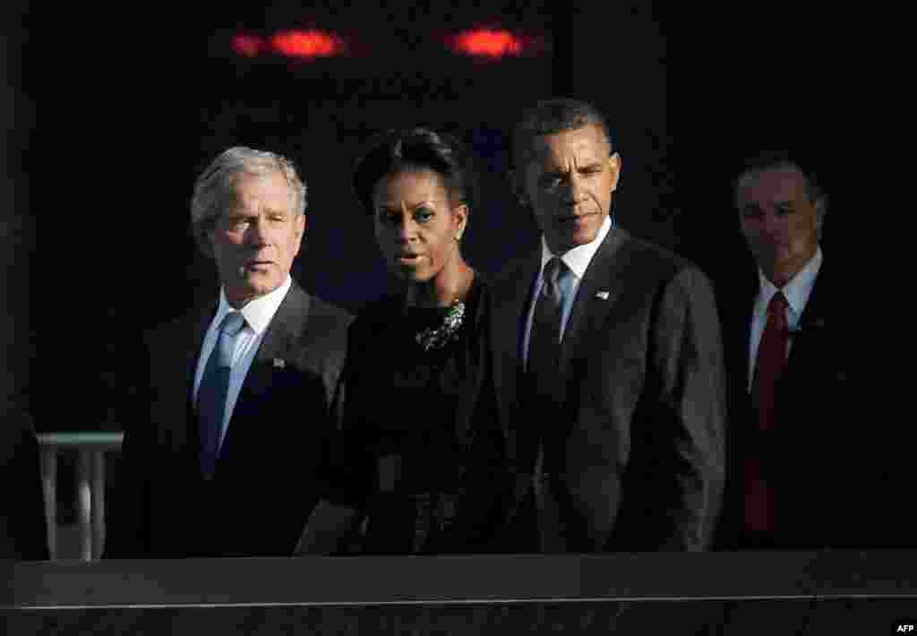 September 11: President Barack Obama, first lady Michelle Obama and former president George W. Bush walk past the North Pool at the National September 11 Memorial during tenth anniversary ceremonies at the World Trade Center in New York. REUTERS/Justin 