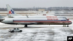 American Airlines jets sit idle after an overnight ice storm forced the closure of DFW International Airport in Dallas, Texas, February 1, 2011