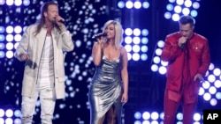 FILE - Tyler Hubbard, right, and Brian Kelley, left, of Florida Georgia Line, join Bebe Rexha to perform "Meant to Be" at the 53rd annual Academy of Country Music Awards at the MGM Grand Garden Arena in Las Vegas. 