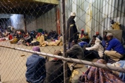 Tobacco farmers prepare to sleep at the auction floors in Harare, Wednesday, April 14, 2021.