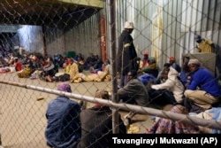 Tobacco farmers prepare to sleep at the auction floors in Harare, Wednesday, April 14, 2021.