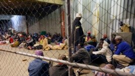 Tobacco farmers prepare to sleep at the auction floors in Harare, Wednesday, April 14, 2021.