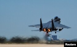 FILE - A Republic of Korea Air Force F-15K Slam Eagles fighter plane takes off during Exercise Max Thunder 17 at Gunsan Air Base, South Korea, April 27, 2017.