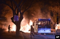 Firefighters work at a scene of fire from an explosion in Ankara that killed 28 people, Feb. 17, 2016.