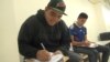 Two Hispanic men register to vote earlier this year in Houston. (G. Flakus/VOA)