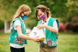 Here, Girl Scouts, Alice (left) and Gracie (right) look at a Wing delivery drone container, Christiansburg, Virginia, April 14, 2021. (Photo provided by Wing LLC.)