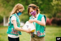 Here, Girl Scouts, Alice (left) and Gracie (right) look at a Wing delivery drone container, Christiansburg, Virginia, April 14, 2021. (Photo provided by Wing LLC.)