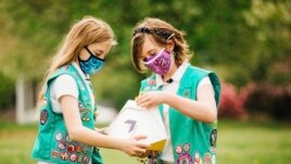 Here, Girl Scouts, Alice (left) and Gracie (right) look at a Wing delivery drone container, Christiansburg, Virginia, April 14, 2021. (Photo provided by Wing LLC.)