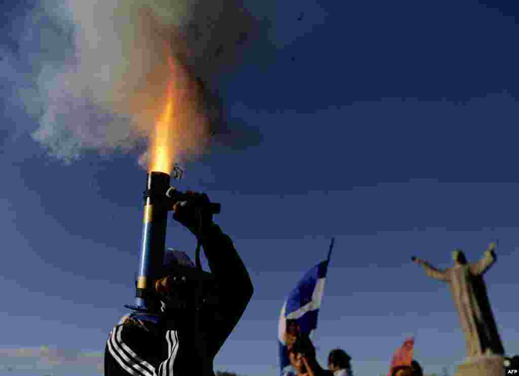 An anti-government protester fires a home-made mortar during a march dubbed &quot;Here nothing is normal&quot;, in Managua, Nicaragua, Aug. 18, 2018.