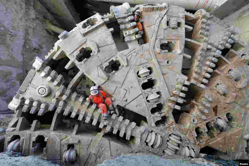 Workers climb out from a tunnel-boring machine (TBM) during the breakthrough of a tunnel for the future tramway line in Nice, France.