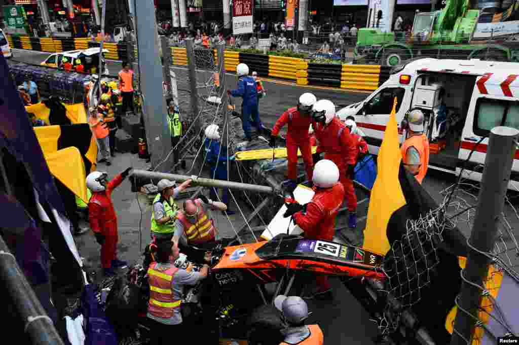 Race employees and pit crew are seen at the accident site after Sophia Floersch, a German driver of Van Amersfoort Racing, flew over the barriers and crashed into a photographers&#39; structure at high speed, during a Formula Three race at the Macau Grand Prix, in Macau, China on November 18, 2018.