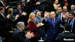 Turkey's Prime Minister Tayyip Erdogan greets his supporters as he arrives at a meeting at the Turkish parliament in Ankara, Feb. 18, 2014. 