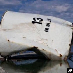 Fuel tank transported by the tsunami in Onagawa, Japan.