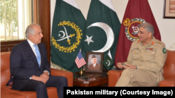 In this photo released by Inter Services Public Relations of Pakistan's military, U.S. peace envoy Zalmay Khalilzad, left, talks with Pakistani Army Chief Gen. Qamar Javed Bajwa during a meeting in Rawalpindi, Pakistan, Dec. 19, 2018. 