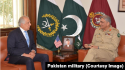 FILE - In this photo released by Inter Services Public Relations of Pakistan's military, U.S. peace envoy Zalmay Khalilzad, left, talks with Pakistani Army Chief Gen. Qamar Javed Bajwa during a meeting in Rawalpindi, Pakistan, Dec. 19, 2018.