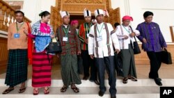 Clad in ethnic Chin and Myanmar traditional attire, newly-elected members of parliament from Myanmar opposition leader Aung San Suu Kyi's National League for Democracy party gather as they visit Lower House of parliament Wednesday, Jan. 27, 2016, in Naypyitaw, Myanmar. The second