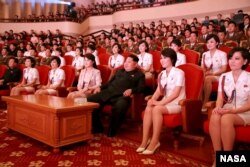 North Korean leader Kim Jong Un (3rd R) and wife Ri Sol Ju (4th L) enjoy an art performance given by the Chongbong Band to mark the 70th anniversary of the founding of the Workers' Party of Korea (WPK)