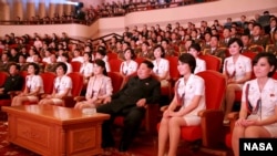 North Korean leader Kim Jong Un (3rd R) and wife Ri Sol Ju (4th L) enjoy an art performance given by the Chongbong Band to mark the 70th anniversary of the founding of the Workers' Party of Korea (WPK) in this undated photo released by North Korea.