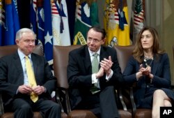 FILE - Attorney General Jeff Sessions, accompanied by Deputy Attorney General Rod Rosenstein and Associate Attorney General Rachel Brand, attend a summit at the Department of Justice in Washington, Feb. 2, 2018.