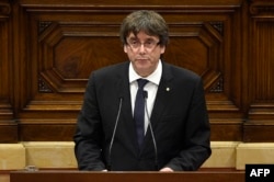 Catalan regional government president Carles Puigdemont gives a speech at the Catalan regional parliament in Barcelona, Oct. 10, 2017.