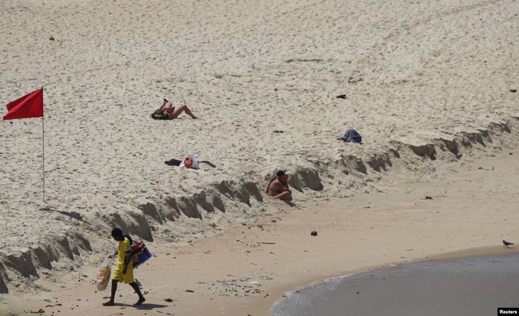 Un vendedor callejero es visto en la playa de Leblon, en Río de Janeiro, Brasil, luego de que las autoridades anunciaran medidas debido al brote de la enfermedad por coronavirus.