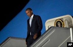 President Barack Obama walks down the steps of Air Force One after arriving at Chopin Airport in Warsaw, Poland, Friday, July 8, 2016.
