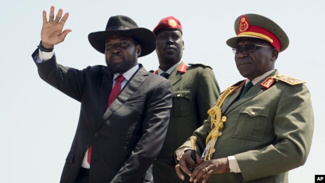 FILE - South Sudan's President Salva Kiir, left, accompanied by army chief of staff Paul Malong, right, waves during an independence day ceremony in the capital Juba, July 9, 2015.