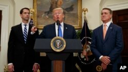 Presiden AS Donald Trump, didampingi Senator Tom Cotton (kiri) dan Senator David Perdue mengumumkan kebijakan baru mengenai imigran legal di Gedung Putih, Rabu (2/8). 