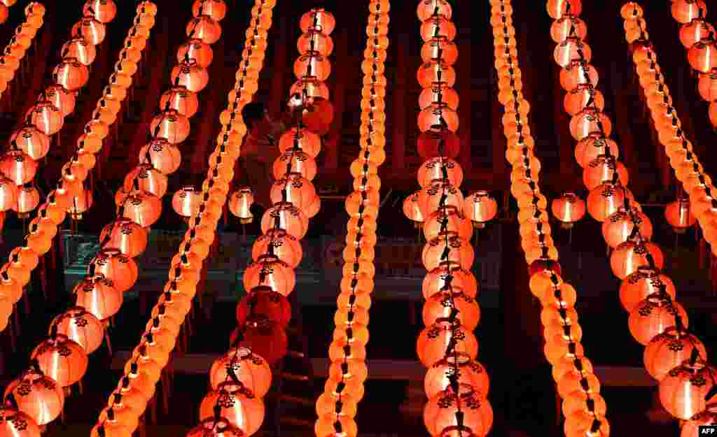 A worker fixes red lanterns ahead of Chinese Lunar New Year celebrations at the Thean Hou Temple in Kuala Lumpur.